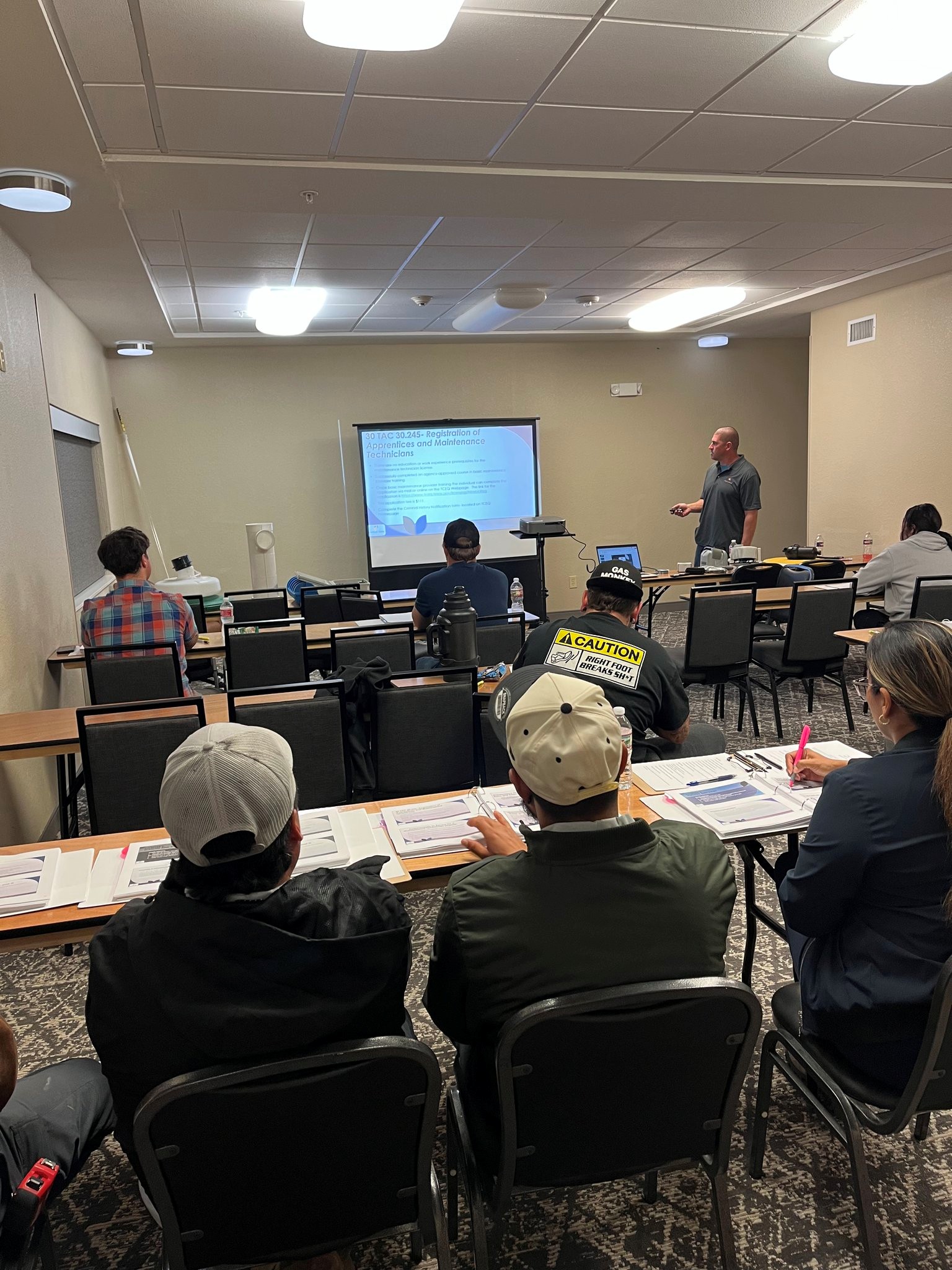 Instructor presenting technical training to attendees in classroom